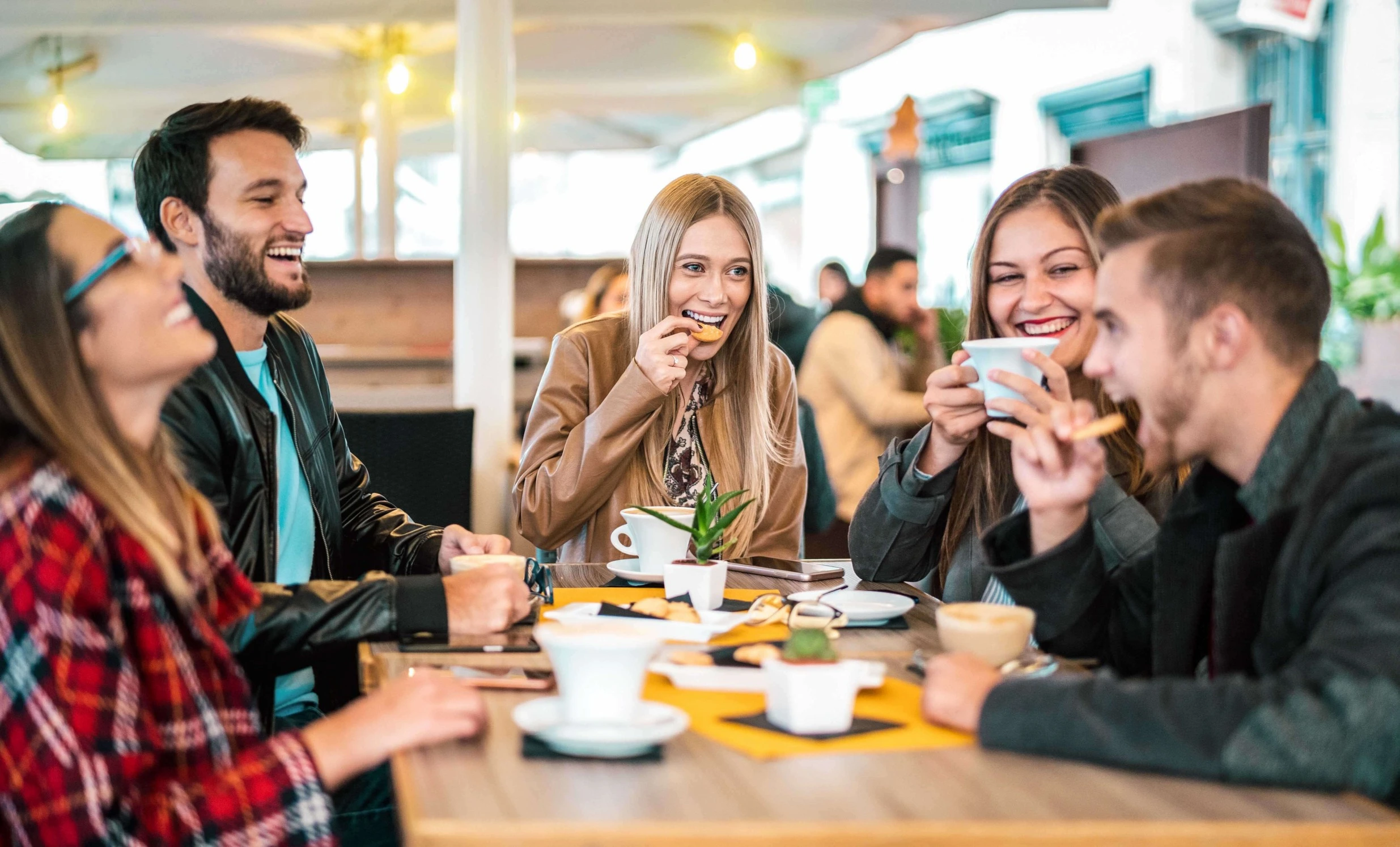 Friends Laughing under Cafe umbrella